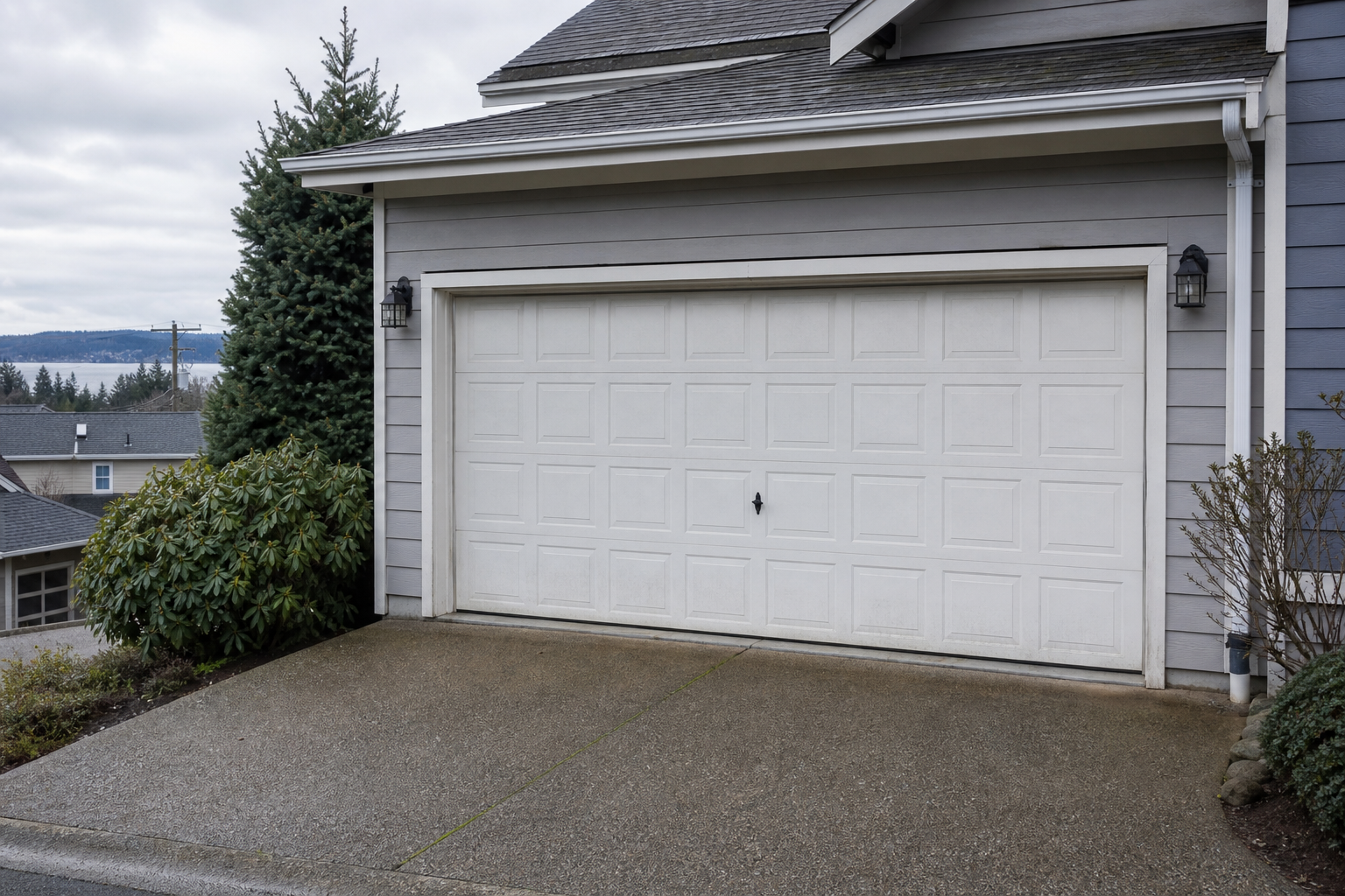 Garage door exterior in Gig Harbor with visible wear on parts and weather seal